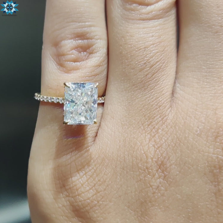 Yellow gold engagement ring with radiant moissanite stone.
