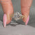 Nature inspired oval engagement ring with four leaf prong setting.
