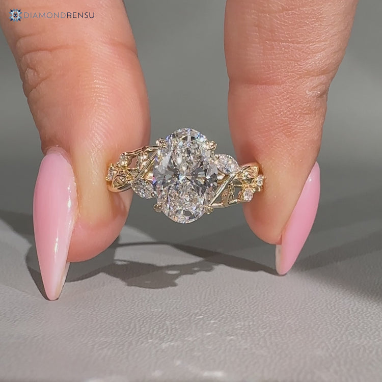 Nature inspired oval engagement ring with four leaf prong setting.
