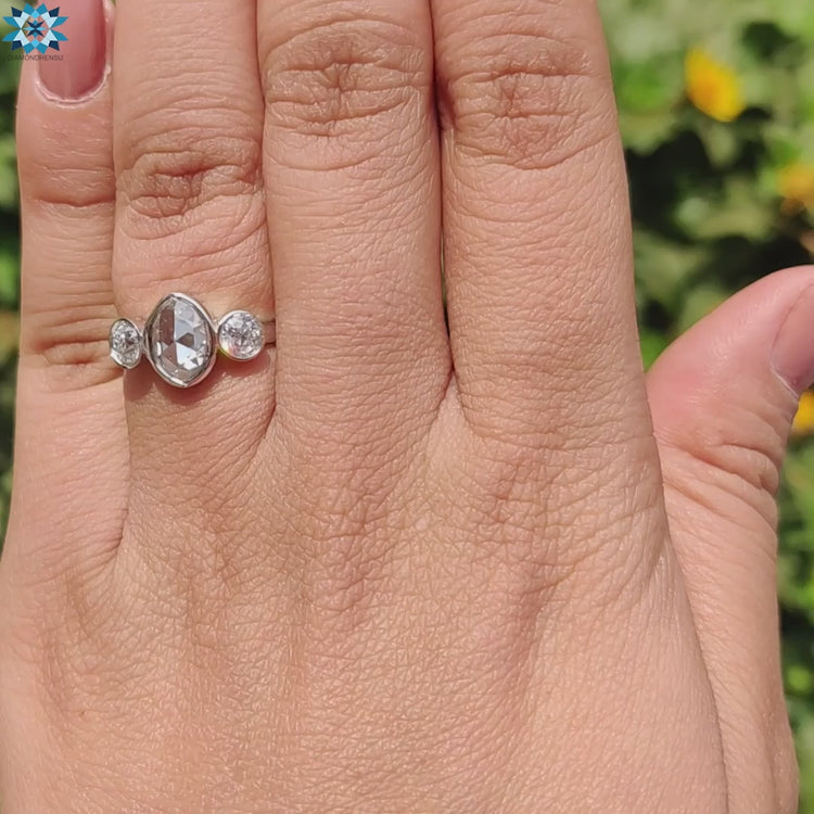 Oval rose cut center stone with old European side stones.
