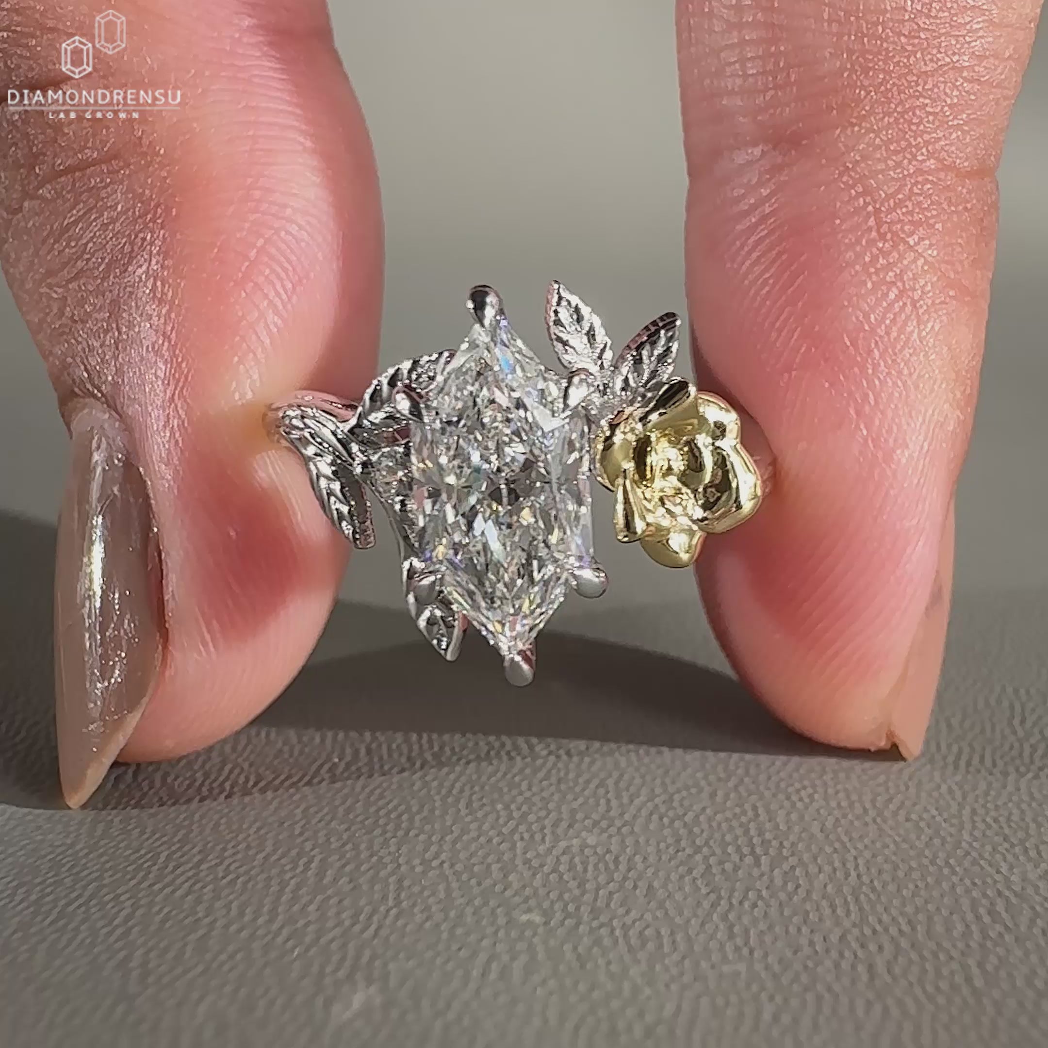 Nature inspired engagement ring in two tone gold with lab diamond centre.
