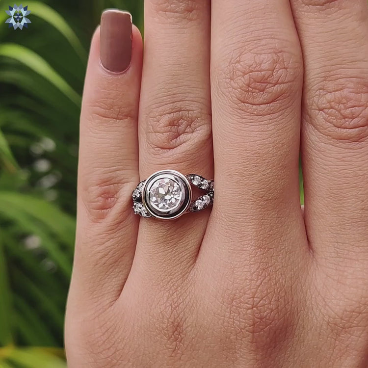Round antique style moissanite ring in prong mount.
