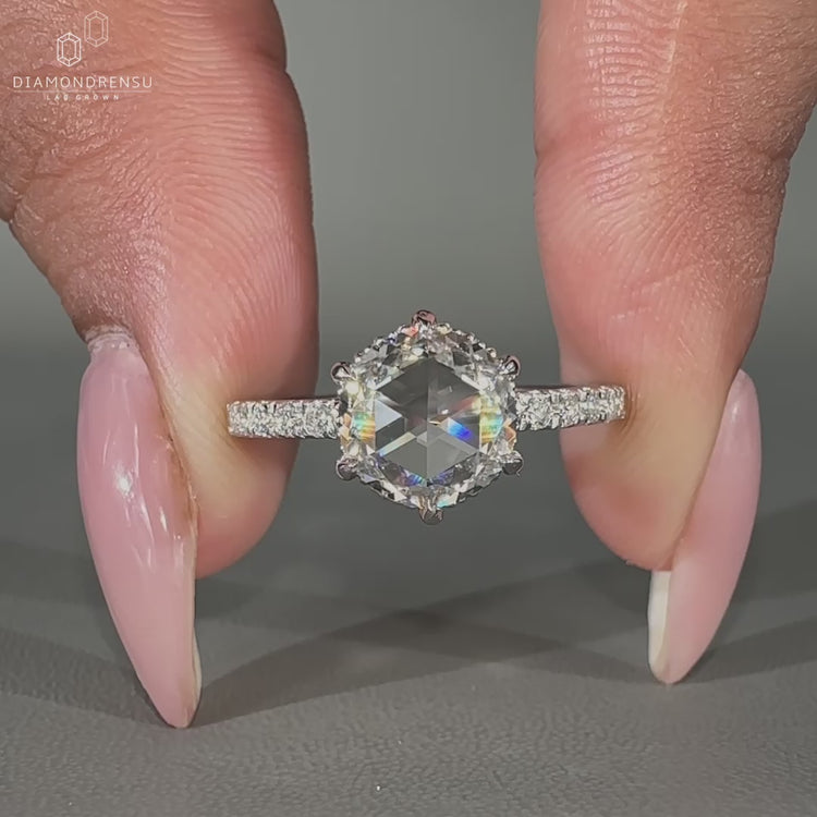 Hidden halo diamond ring featuring milgrain detail and white gold band.
