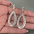 Baguette and round diamond earrings in cluster style.
