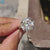 3 Stone Engagement Ring with cushion cut moissanite and tapered baguette accents.