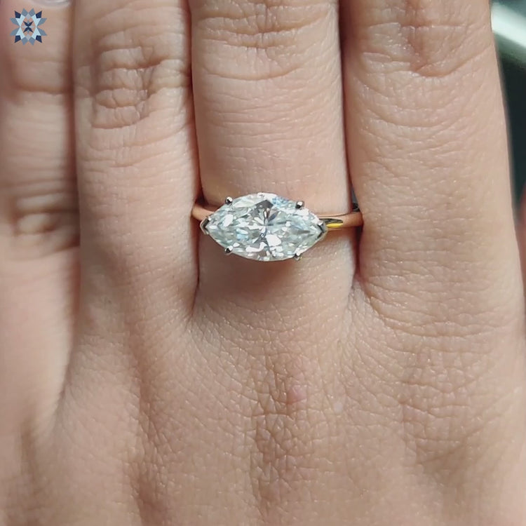 Dual-tone engagement ring with marquise cut and 6 prong setting.
