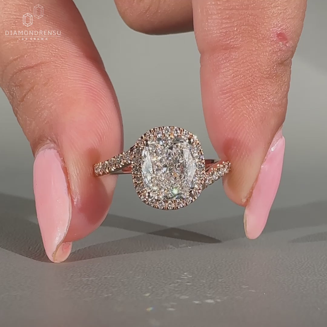Cushion cut diamond ring with round cut halo.
