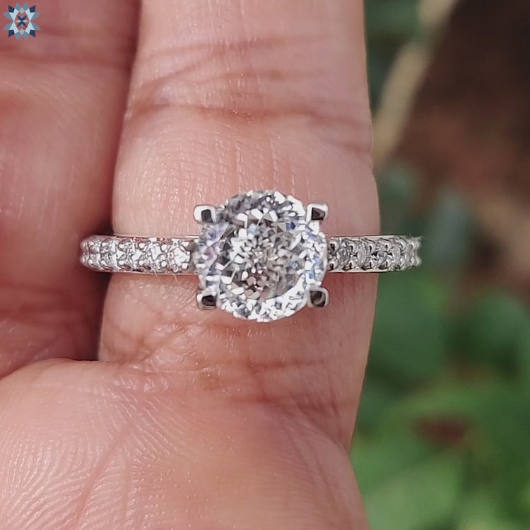 White gold prong setting ring with pave accents.
