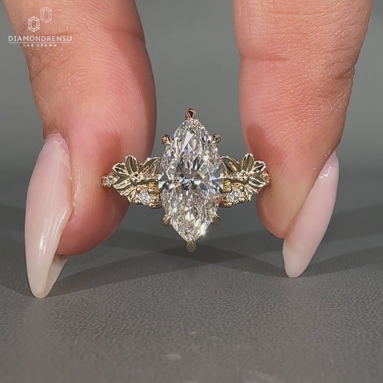 Handmade marquise diamond ring with round side stones.