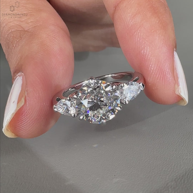 UK engagement ring with three stone design.
