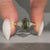Green hexagon diamond ring with trillion side stones.