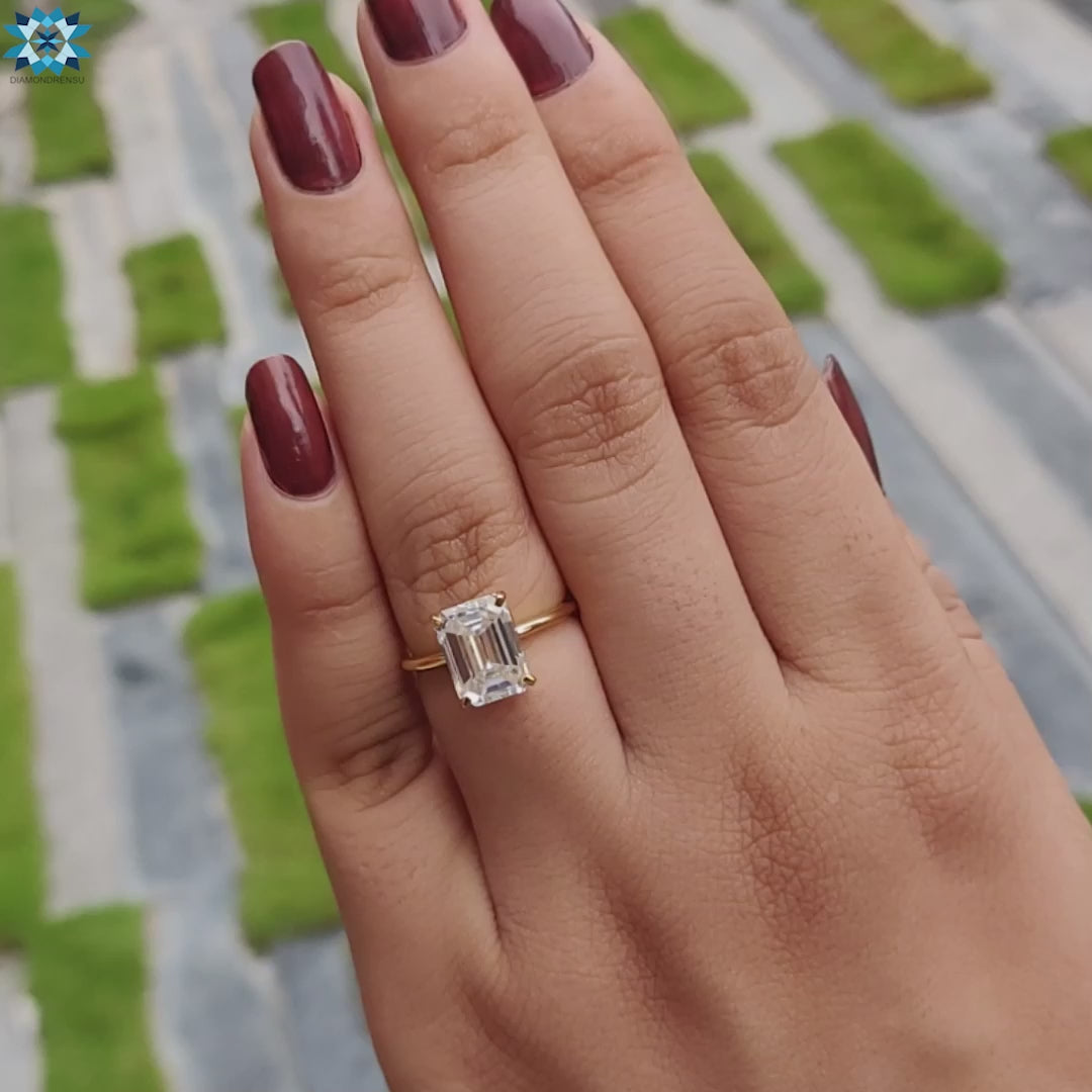 A beautiful emerald cut moissanite engagement ring featuring a unique 4 prong ring setting.
