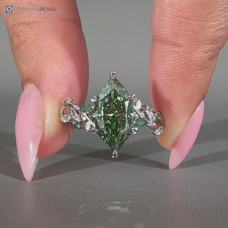 Handmade marquise ring with moss agate side stones.