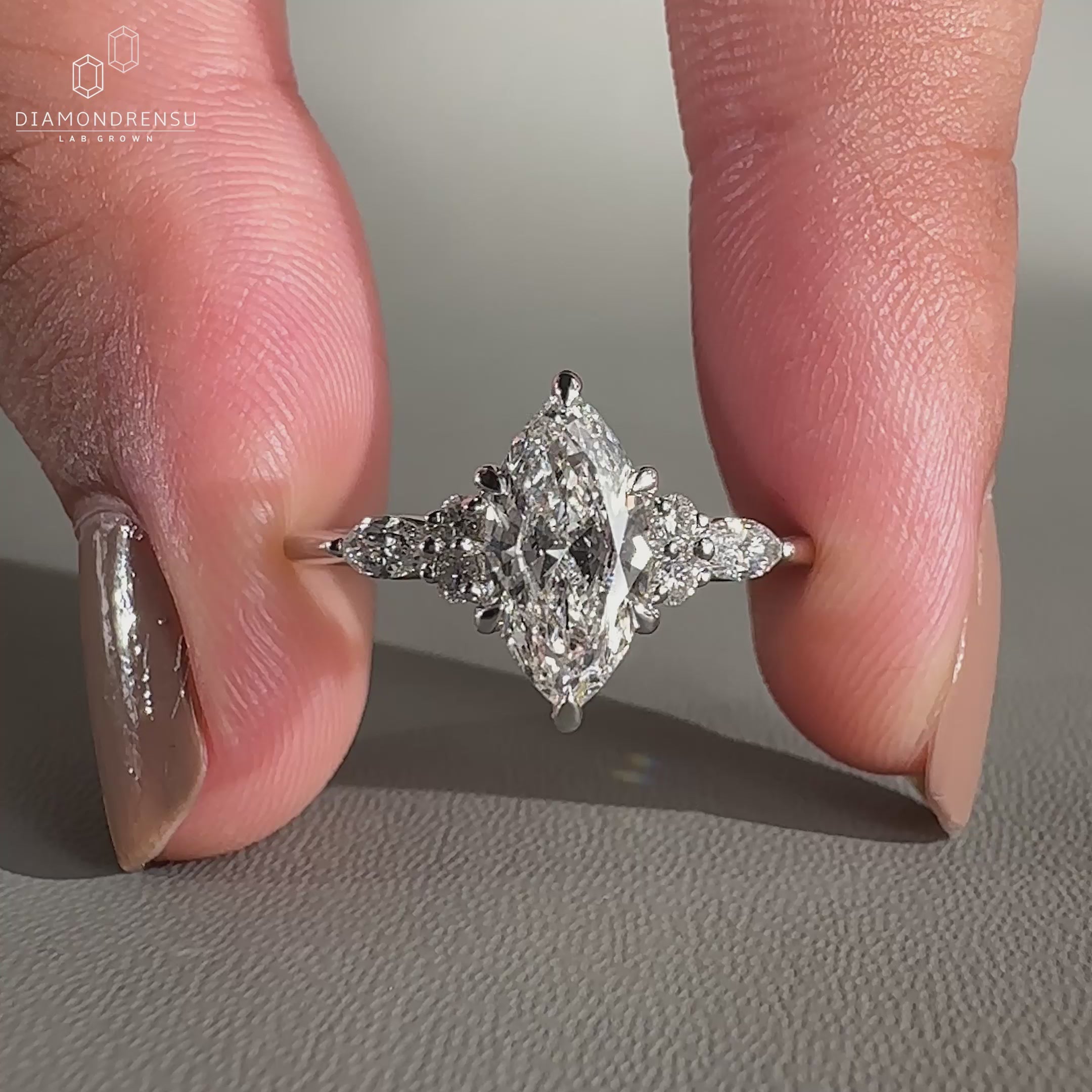 Marquise and round side stones styled in muse setting.
