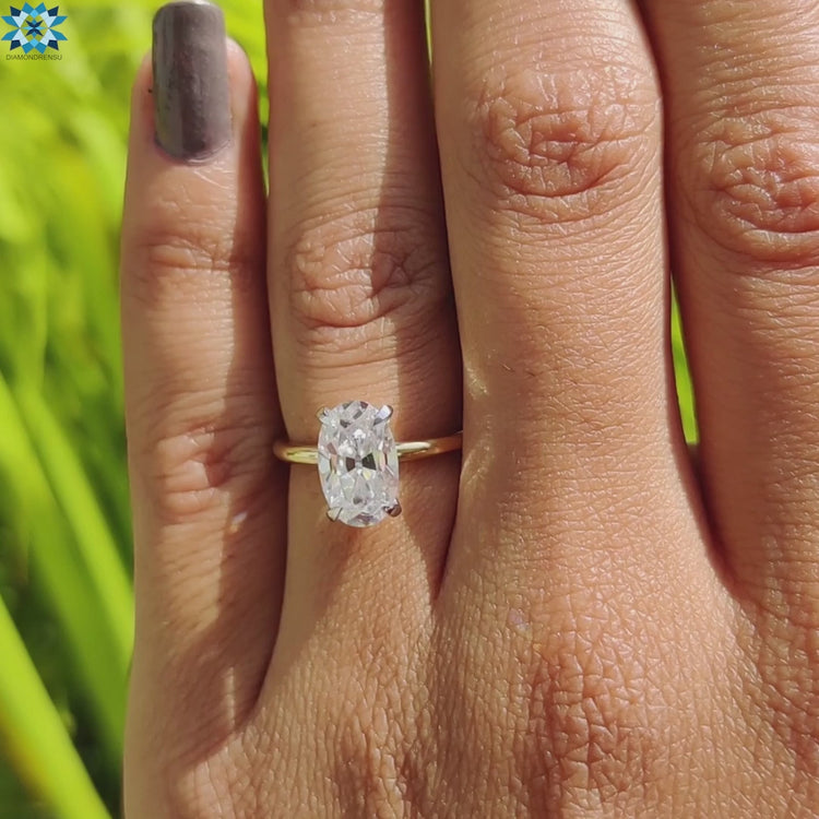 Four prong solitaire moissanite ring in yellow gold.
