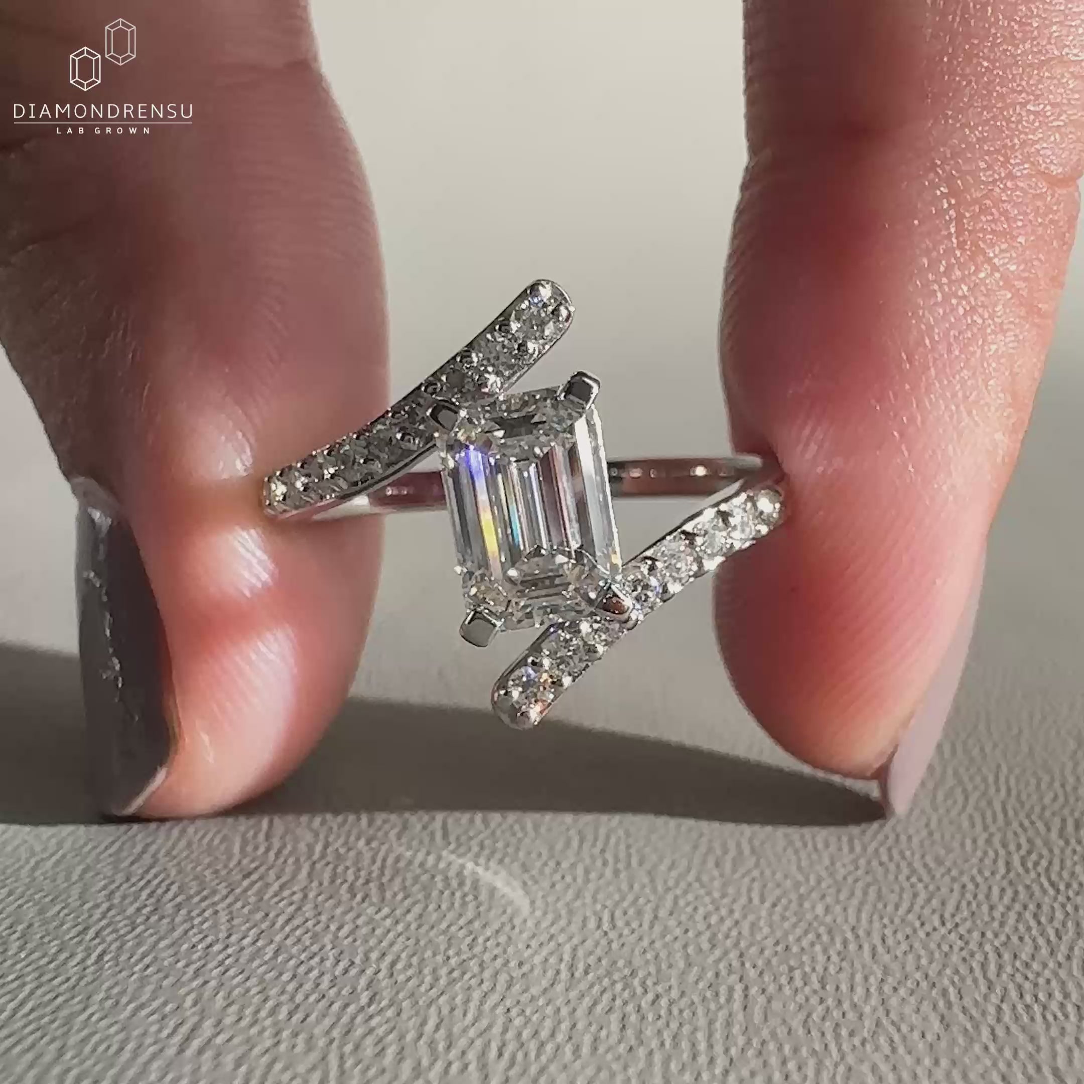 Bypass engagement ring featuring pave and prong setting details.

