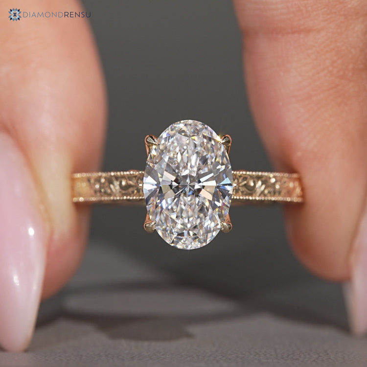 Vintage oval diamond ring with milgrain details.