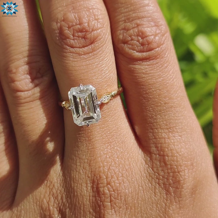 Custom handmade emerald cut moissanite ring in yellow gold.
