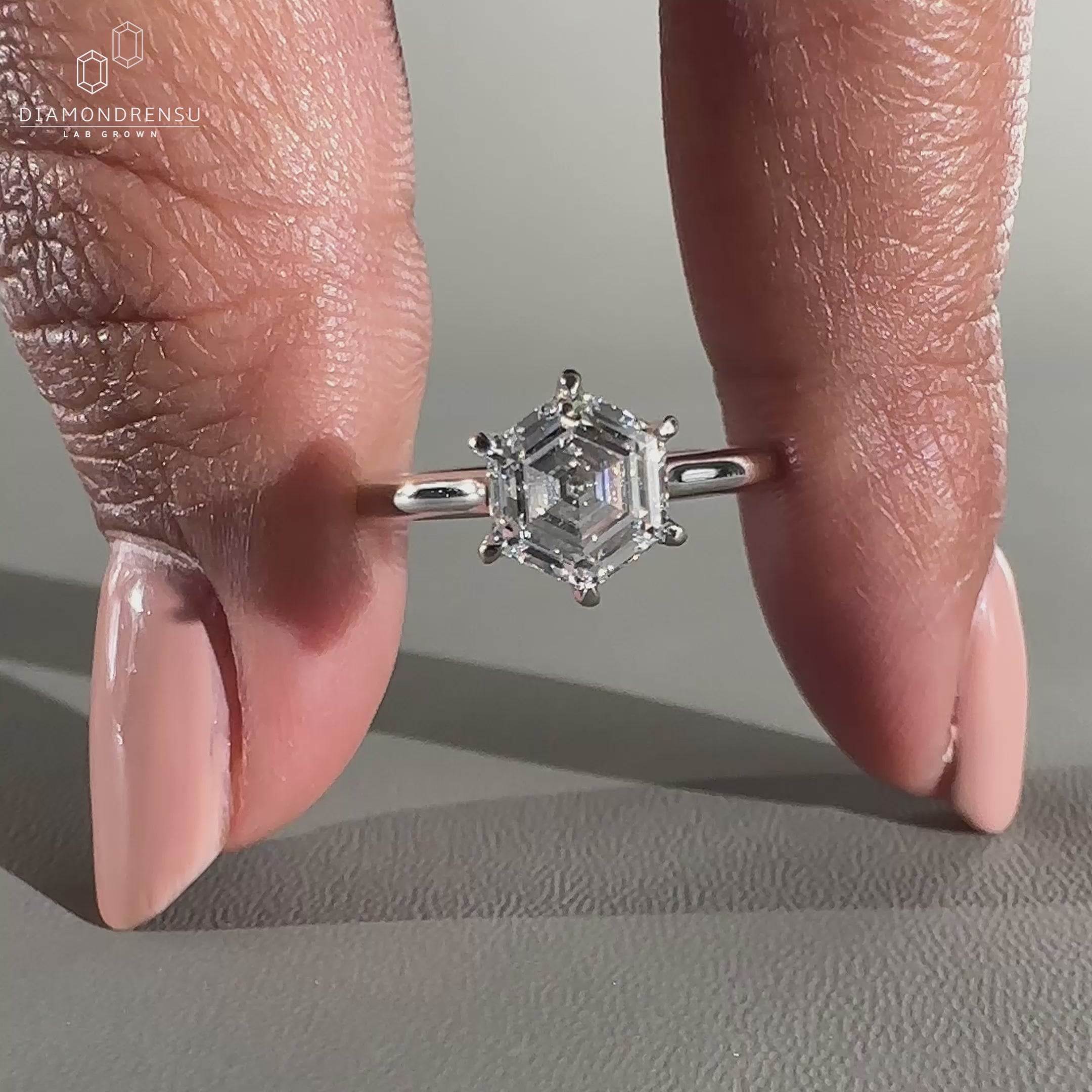 Hexagon ring in a cathedral setting made of white gold.
