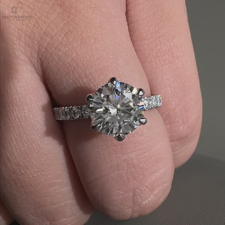 Engagement ring for women featuring a round diamond in a pave setting, available as a diamond ring uk design.
