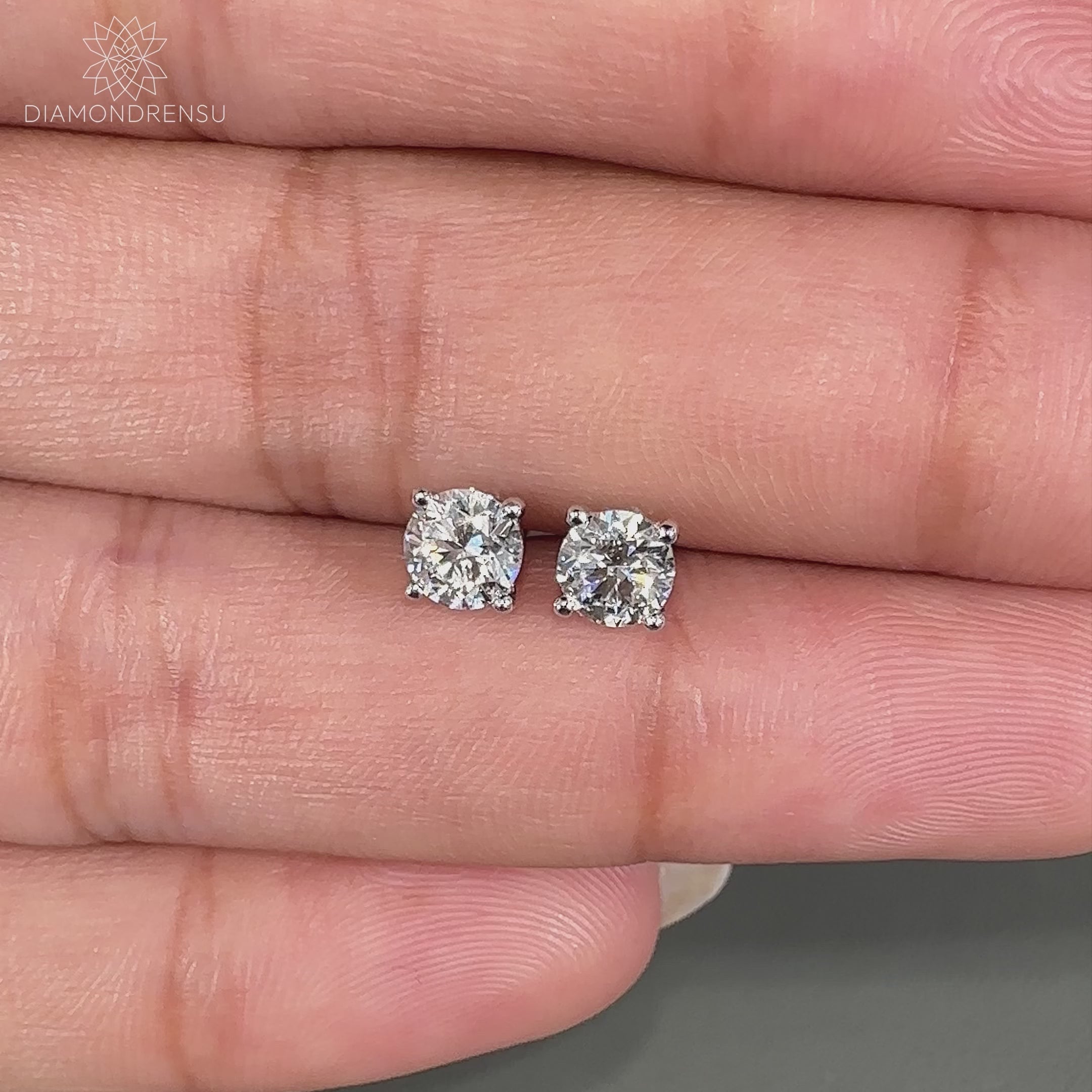 Handmade white gold stud earrings featuring lab grown diamonds.