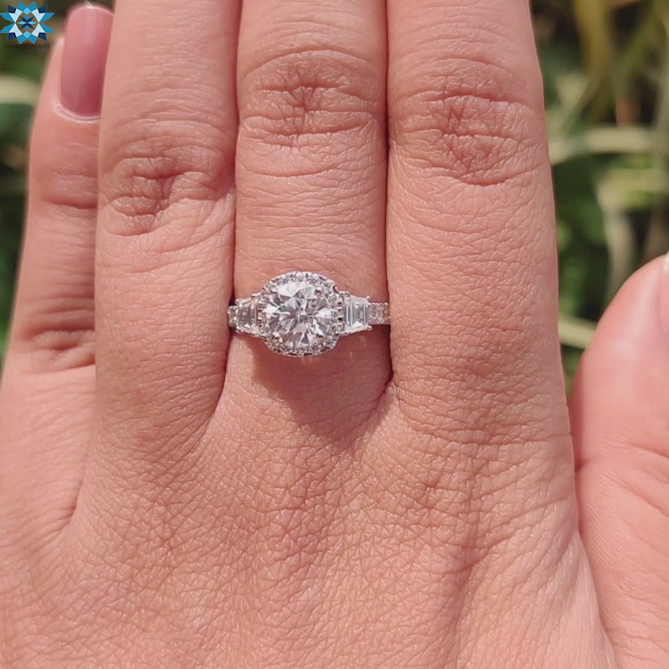 Round moissanite ring in white gold with halo setting and pave detail.
