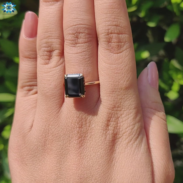 Black moissanite solitaire ring with claw prongs.

