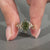 Handmade marquise ring with round side stones and leaf prongs.