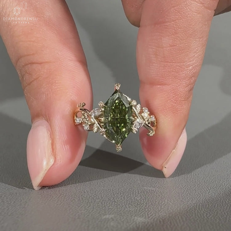 Handmade marquise ring with round side stones and leaf prongs.