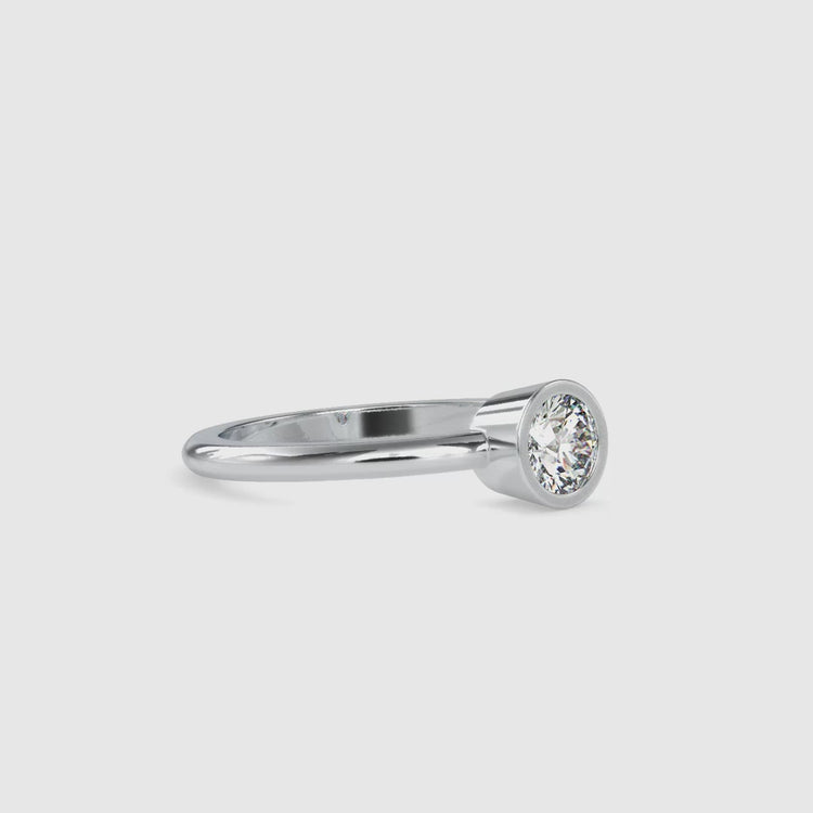 Round diamond ring with bezel mount and sleek custom shank.
