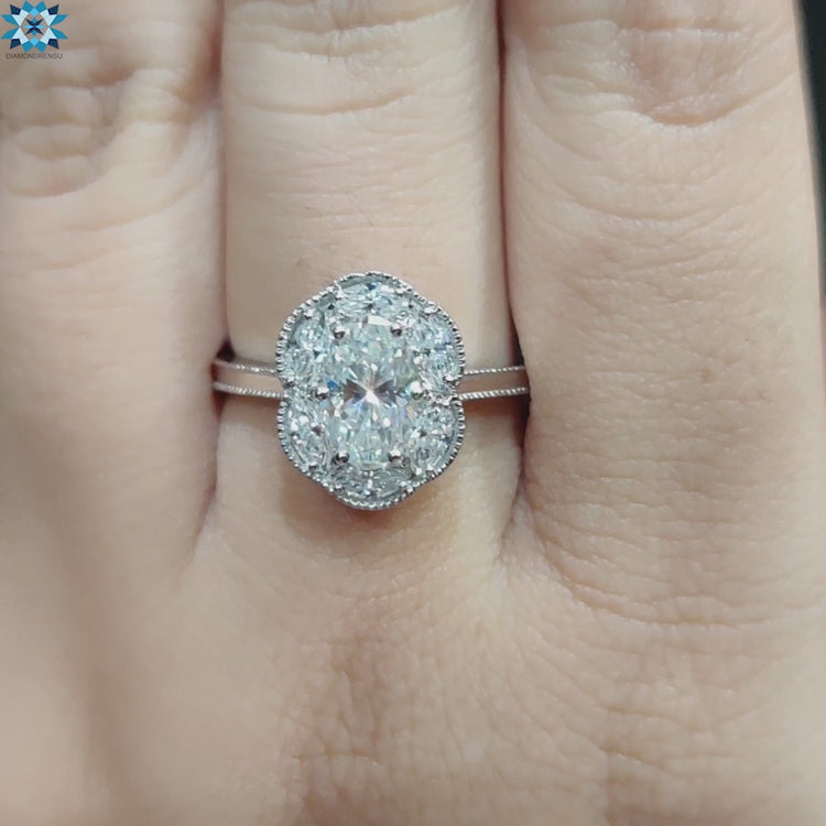 Prong set moissanite ring with marquise cut halo cluster.
