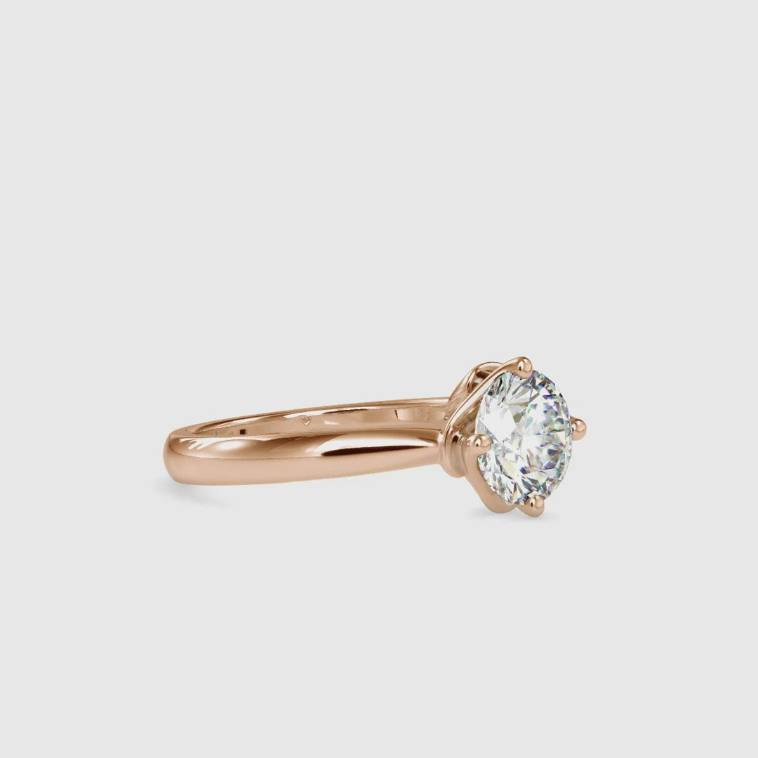 Handmade diamond solitaire ring round in four-prong setting.