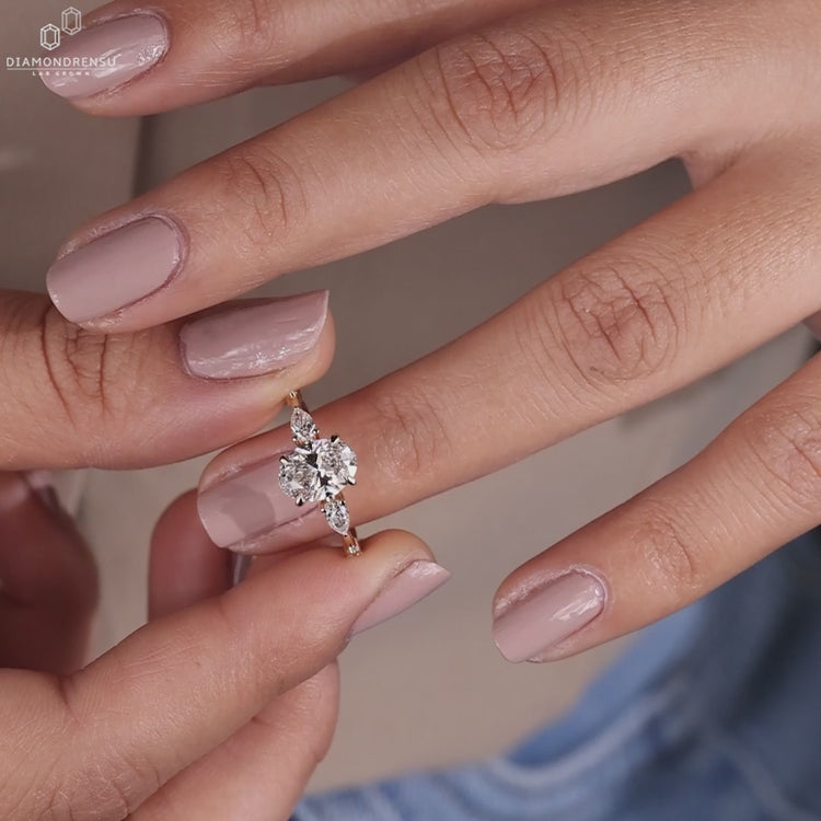 Oval engagement ring with round side stones and a stunning claw prong setting for timeless UK engagement traditions.
