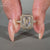 This emerald engagement ring features a two side halo ring and pave setting ring.
