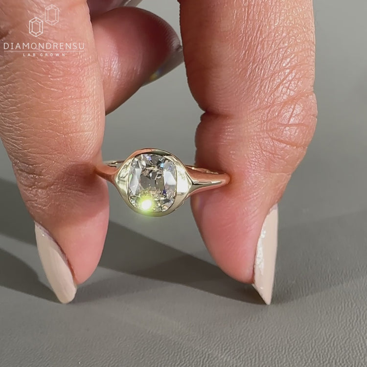 Old mine cushion cut diamond ring as solitaire engagement ring.
