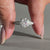 Round diamond ring designed with tapered pave set.
