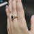 Halo engagement ring with black moissanite center.