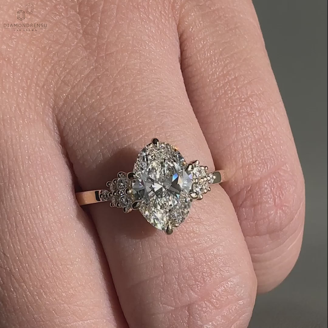 Woman wearing an oval diamond ring with claw prongs