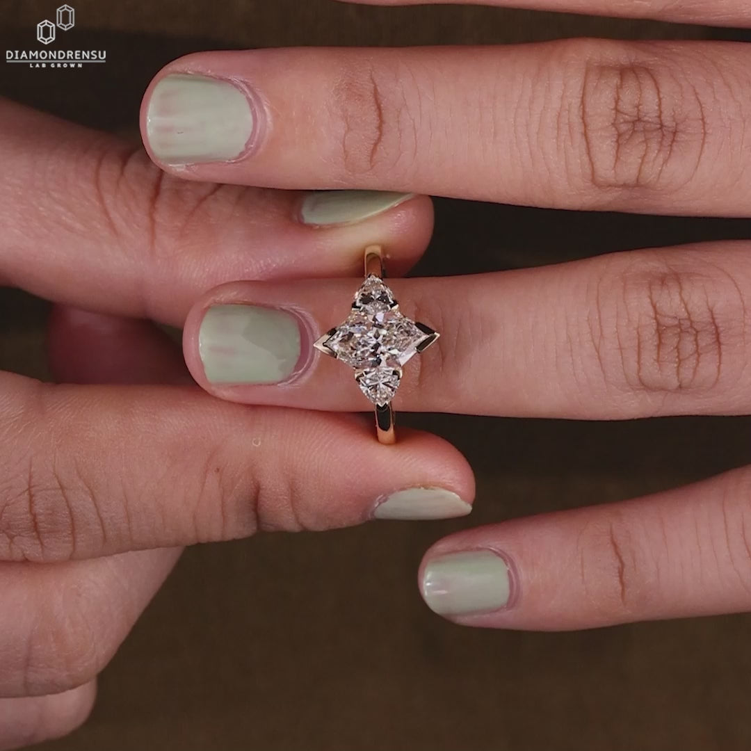 Three stone diamond ring on a model's hand, showcasing its sparkle.