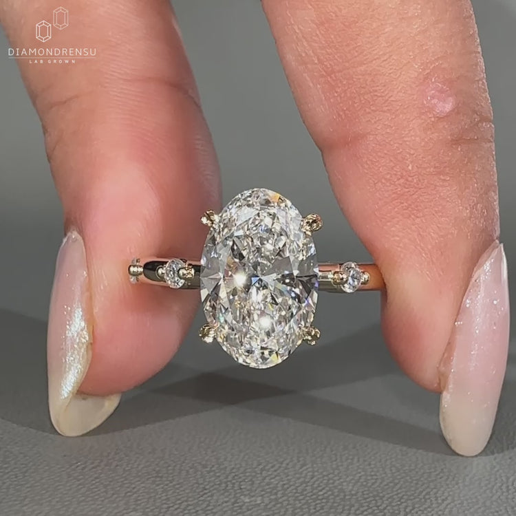 Leaf style prong ring featuring an oval diamond center stone.
