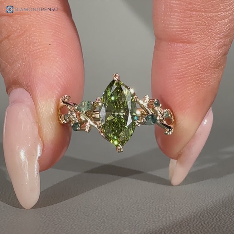 Green centre diamond ring with marquise moss agate side stones.