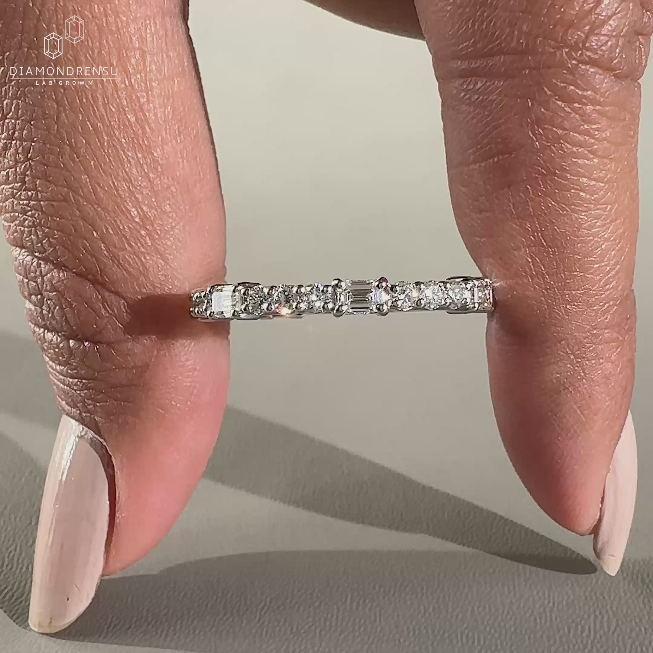 White gold wedding band with round cut diamonds.
