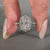 Halo setting ring featuring a radiant cut center stone.
