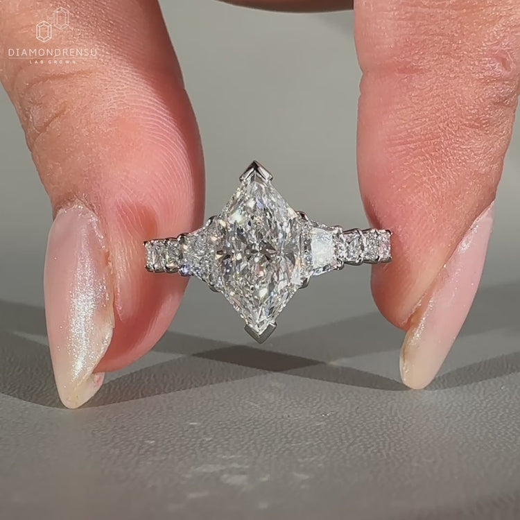 Engagement ring with 2 trapezoid brilliant side stones.
