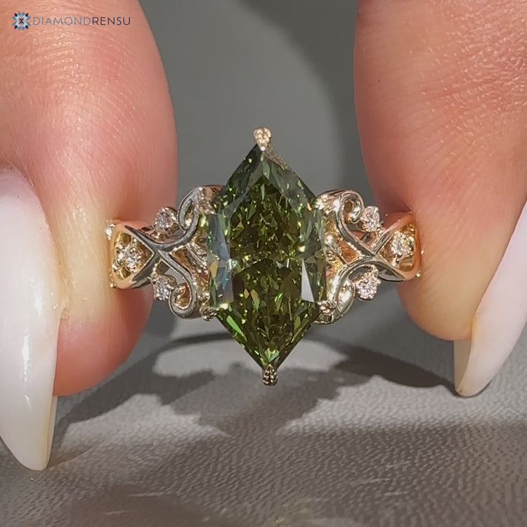 Green centre diamond ring with round side stones.