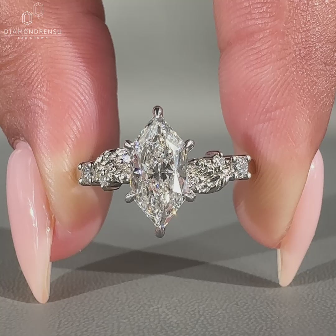 Round side stone ring with leaf style design and 6 prong claw setting.
