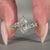 Round side stone ring with leaf style design and 6 prong claw setting.
