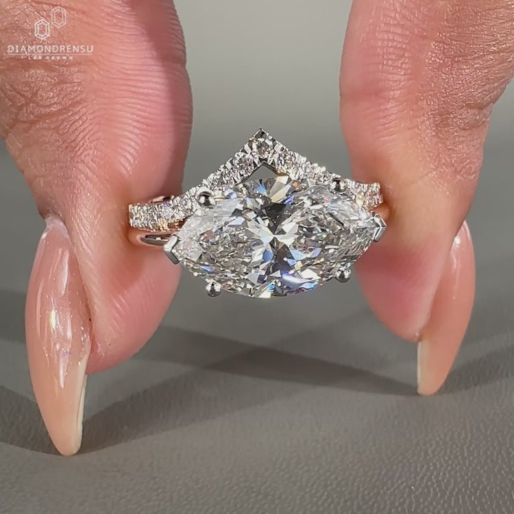 East west engagement ring with dual shank and two tone style.
