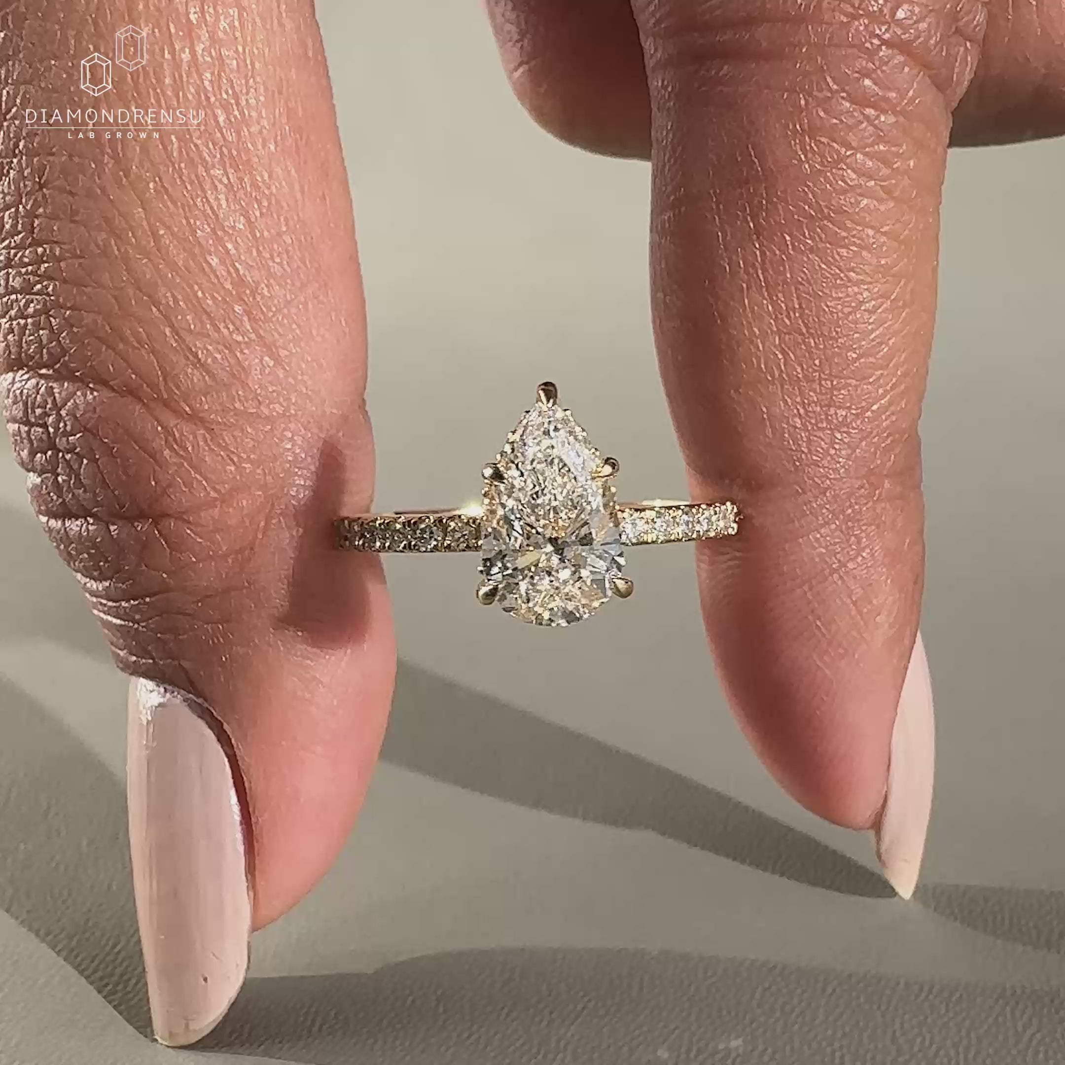 Pear cut diamond engagement ring with claw prong ring setting.
