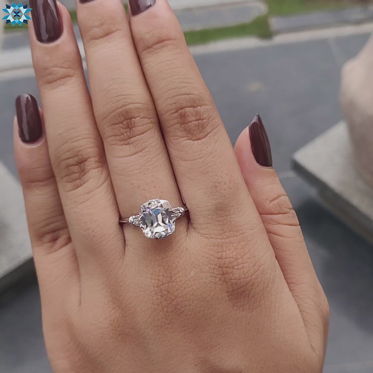 Custom moissanite engagement ring with cushion center.
